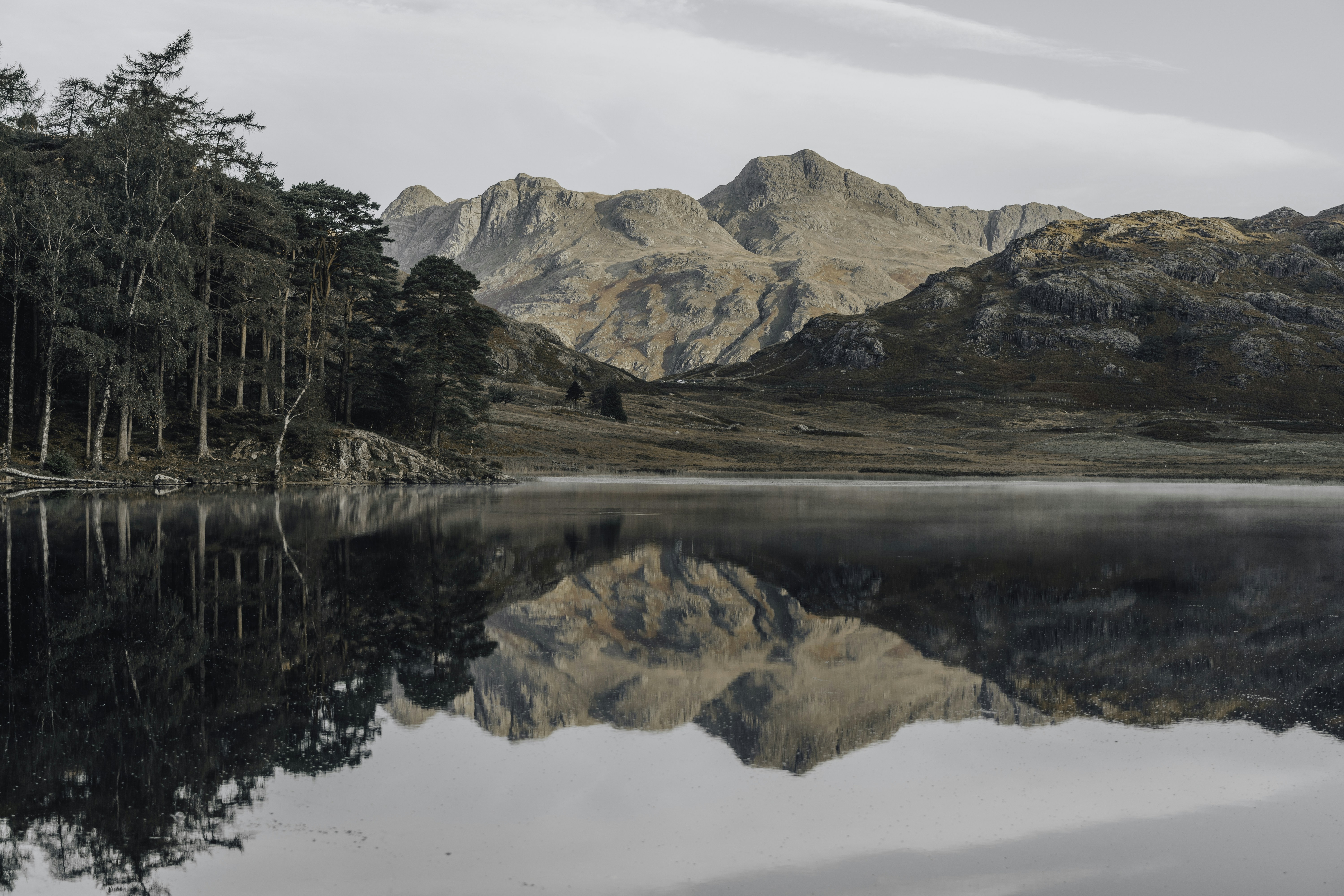 a lake surrounded by mountains and trees