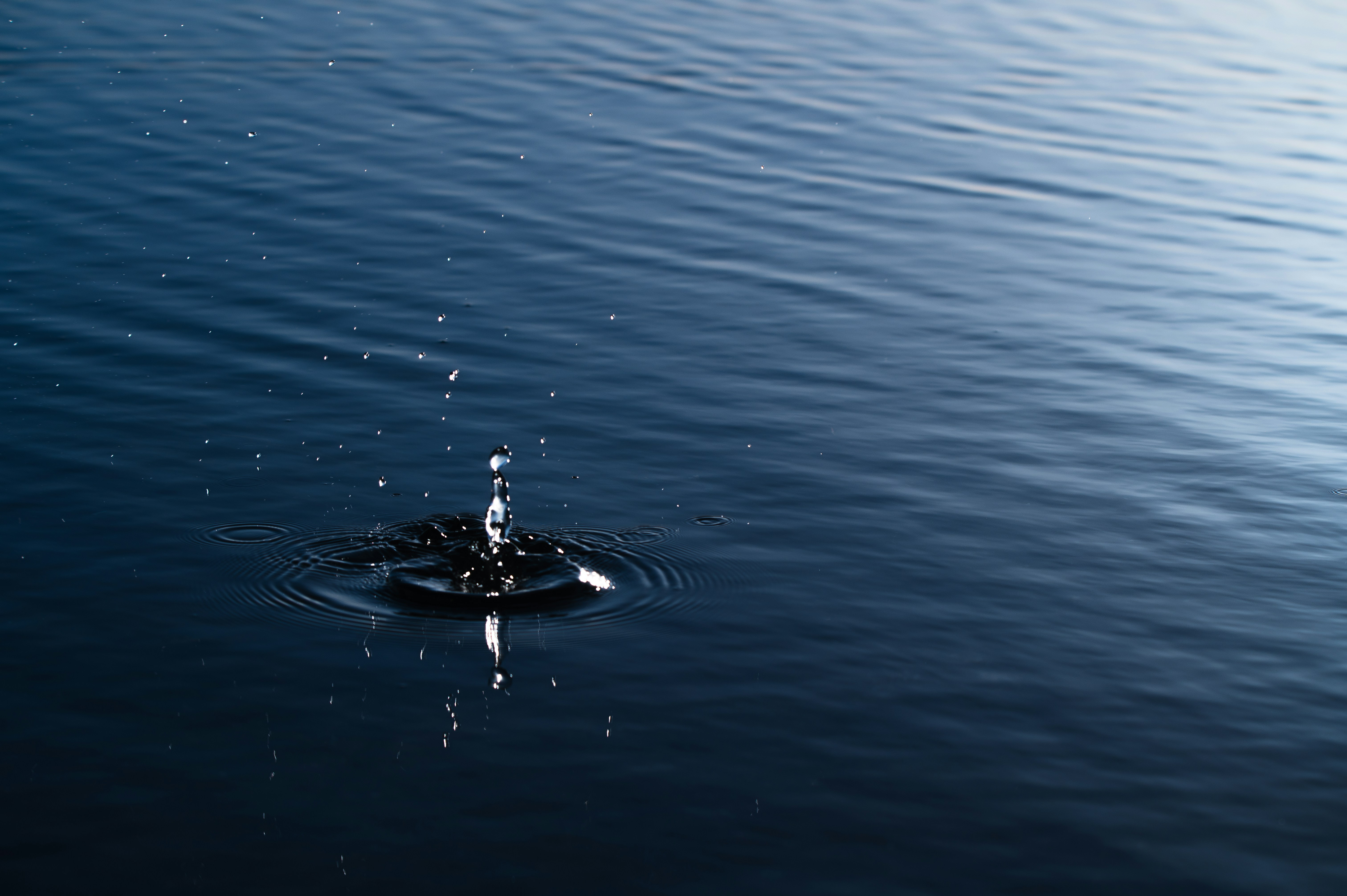 A single drop of water falling into a body of water photo – Free Japan ...