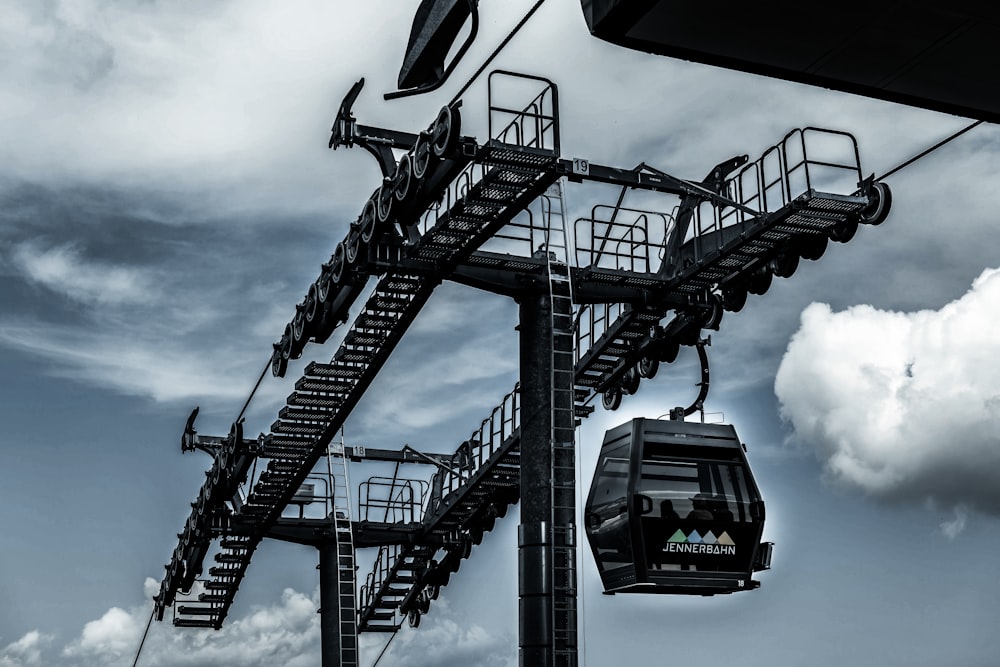 a black and white photo of a ski lift