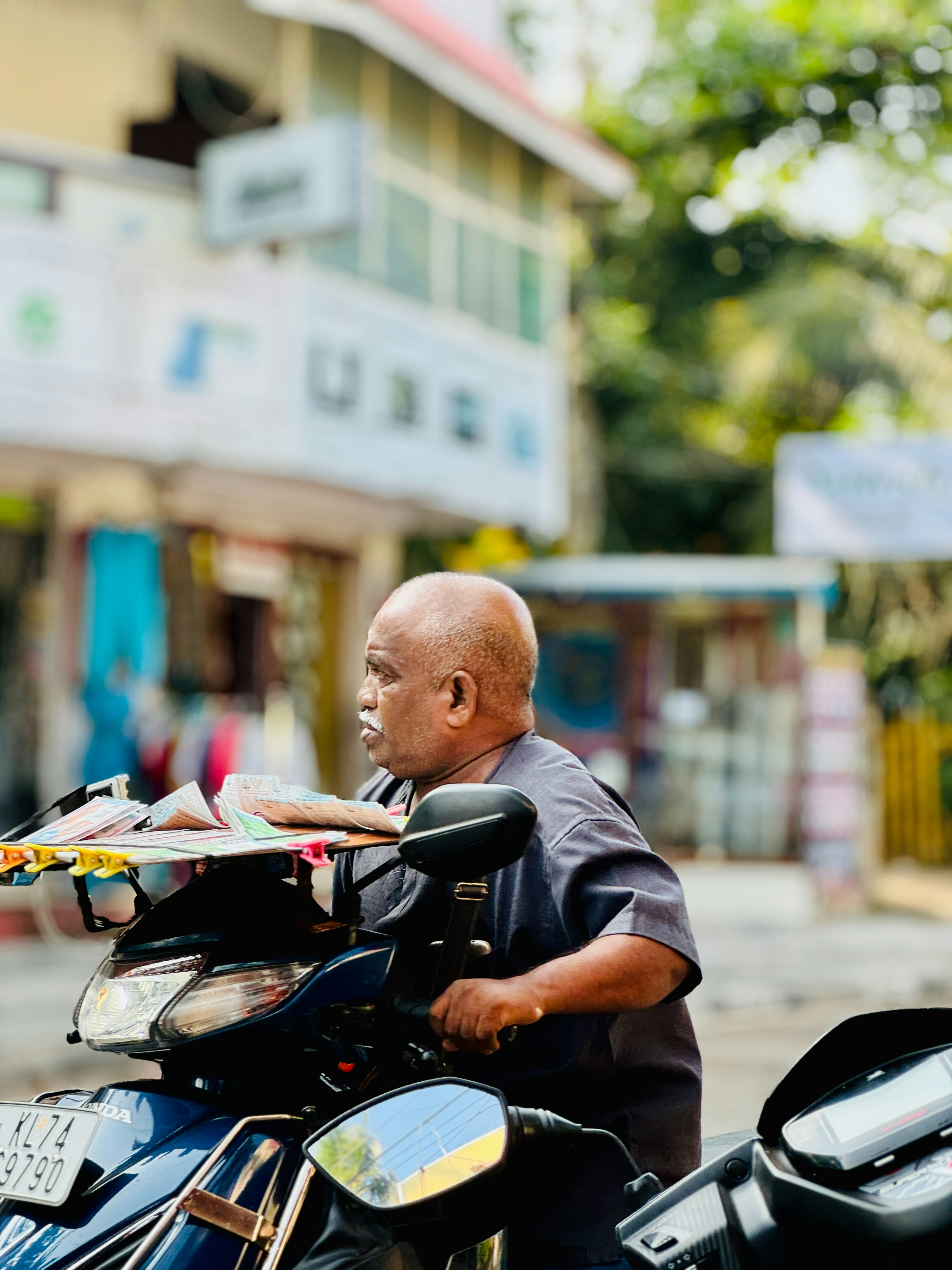 a man riding a motorcycle down a street