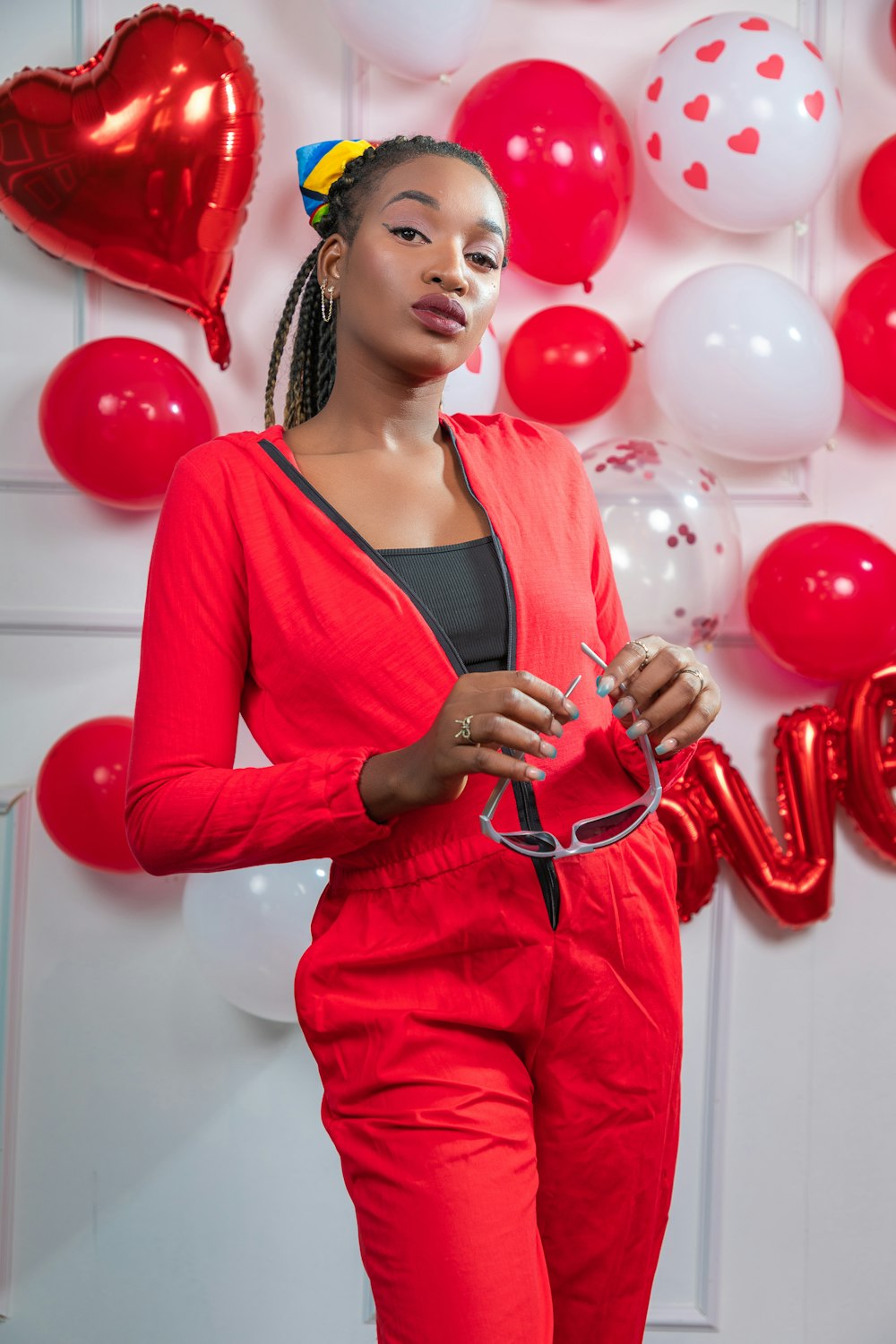 a woman standing in front of balloons and balloons