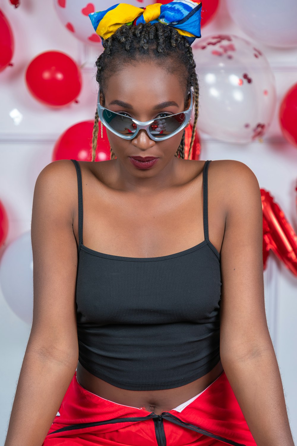 a woman wearing a black top and a red skirt