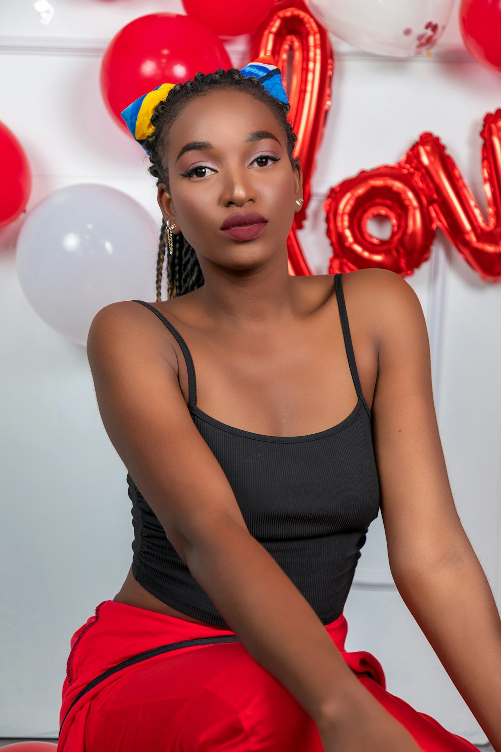 a woman sitting in front of balloons and balloons