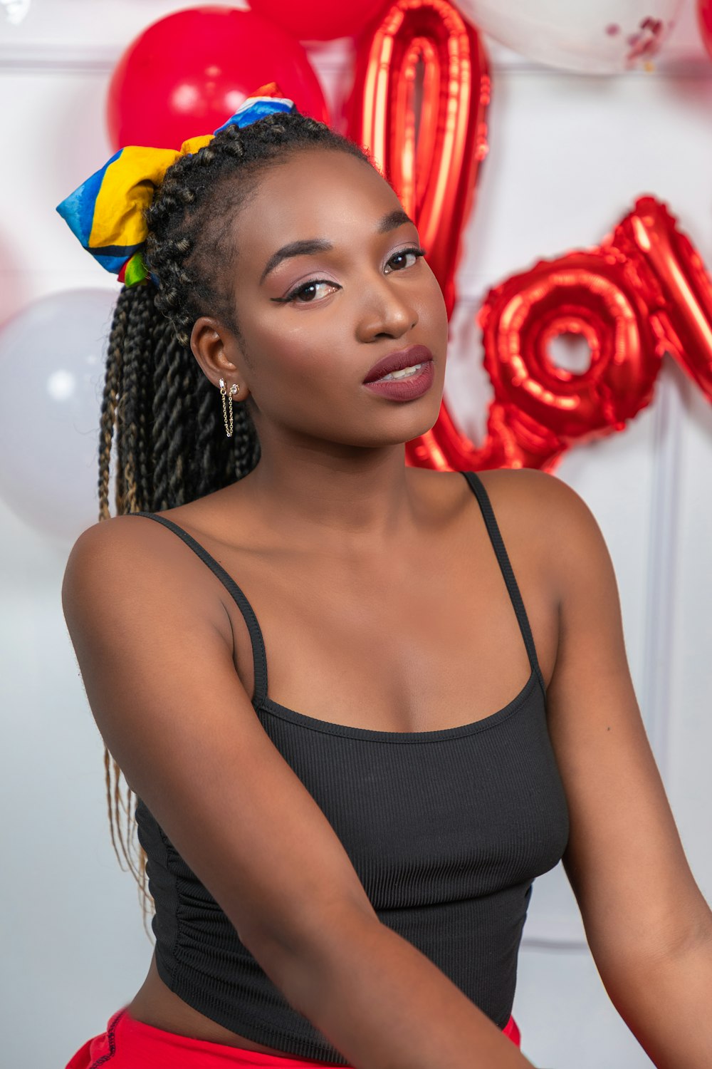 a woman in a black top and red skirt