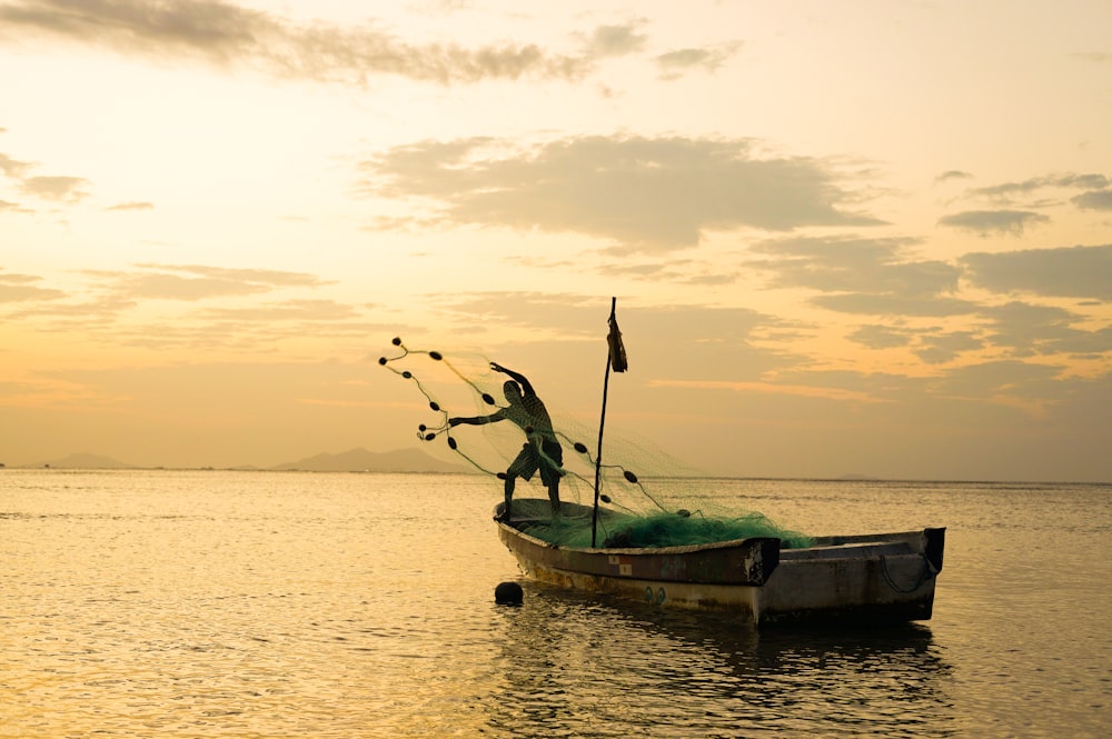 a man standing on a boat in the water