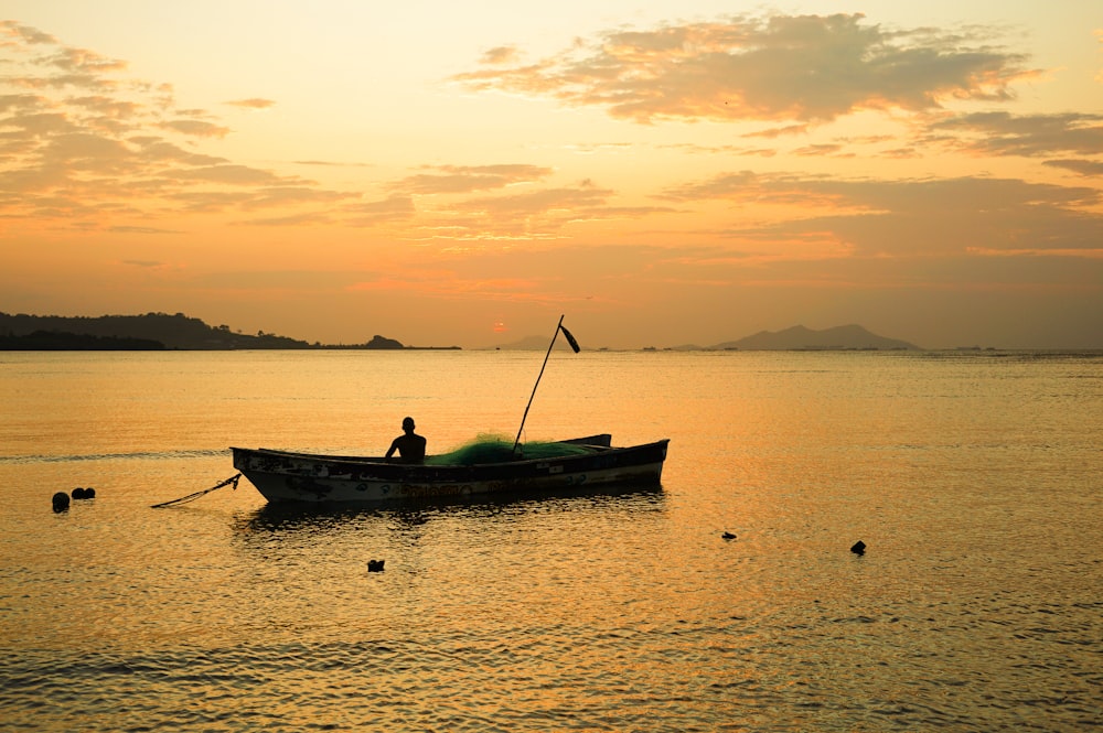 a person in a small boat on a body of water