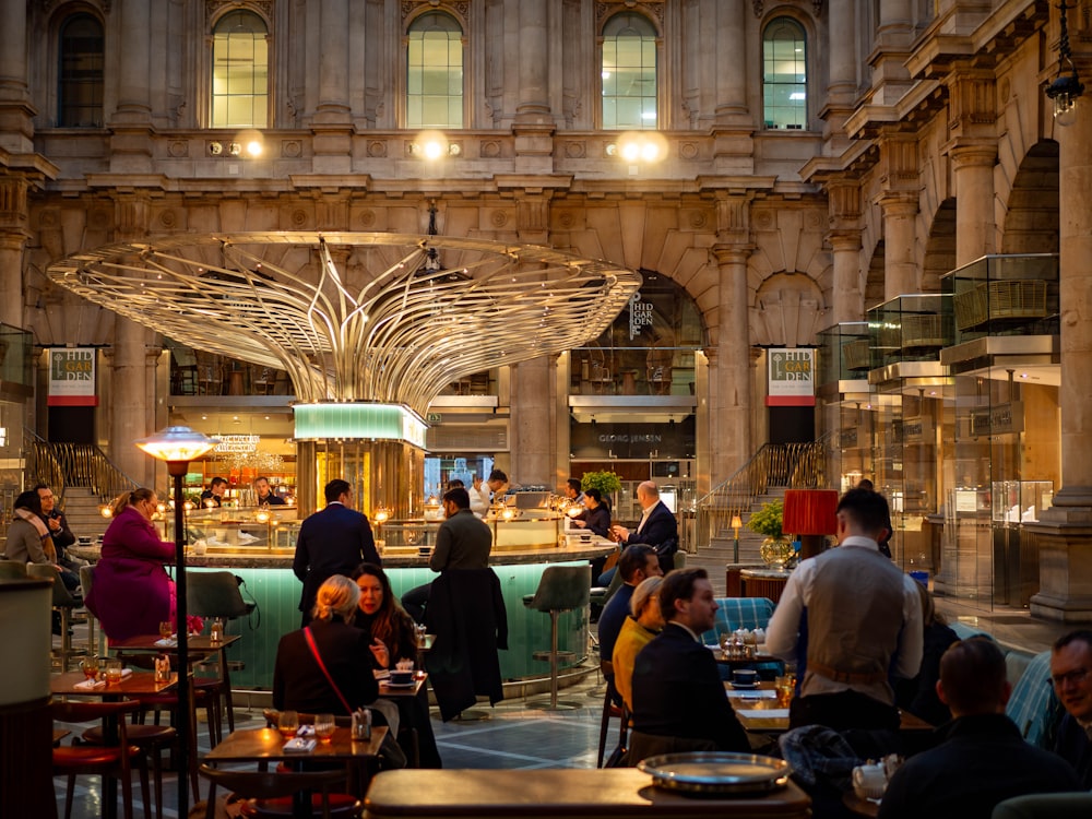 a group of people sitting at tables in a restaurant