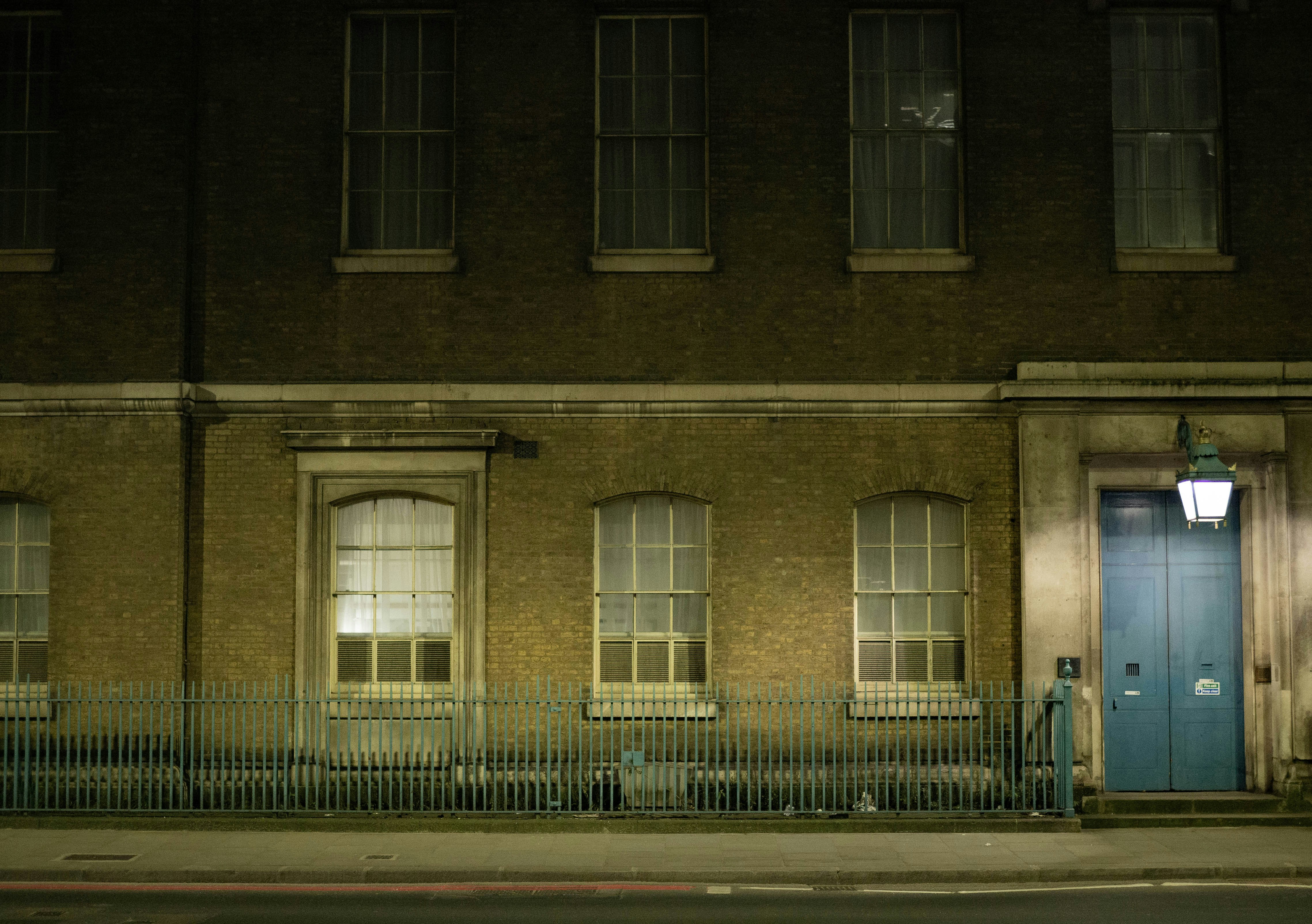 a building with a blue door at night