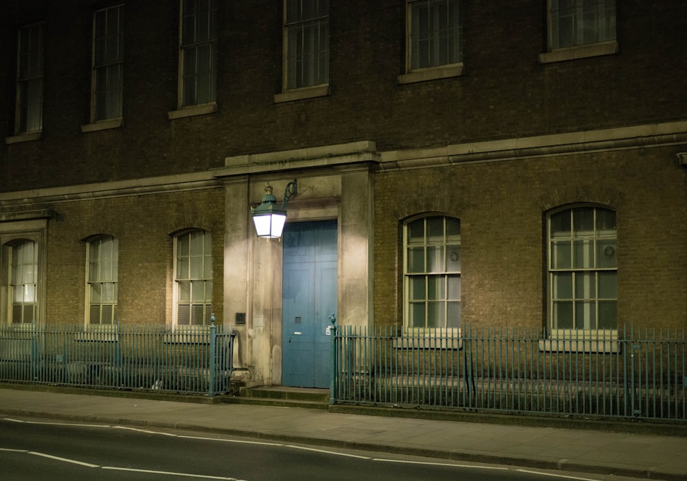 a building with a blue door at night