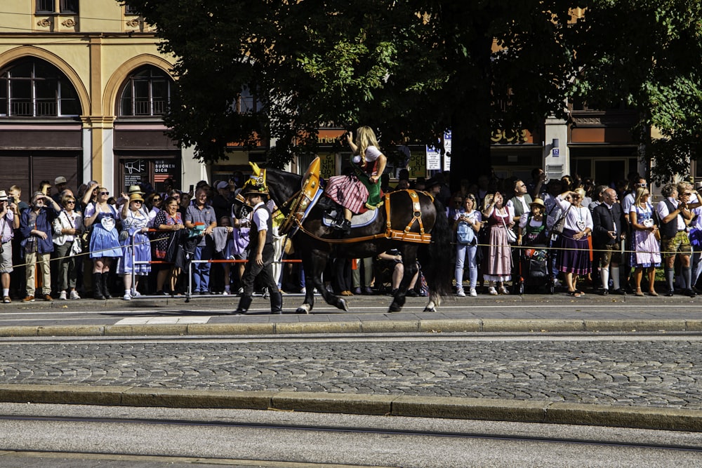 a man riding on the back of a black horse