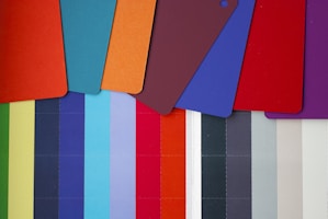 a group of different colored cutting boards next to each other
