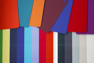 a group of different colored cutting boards next to each other