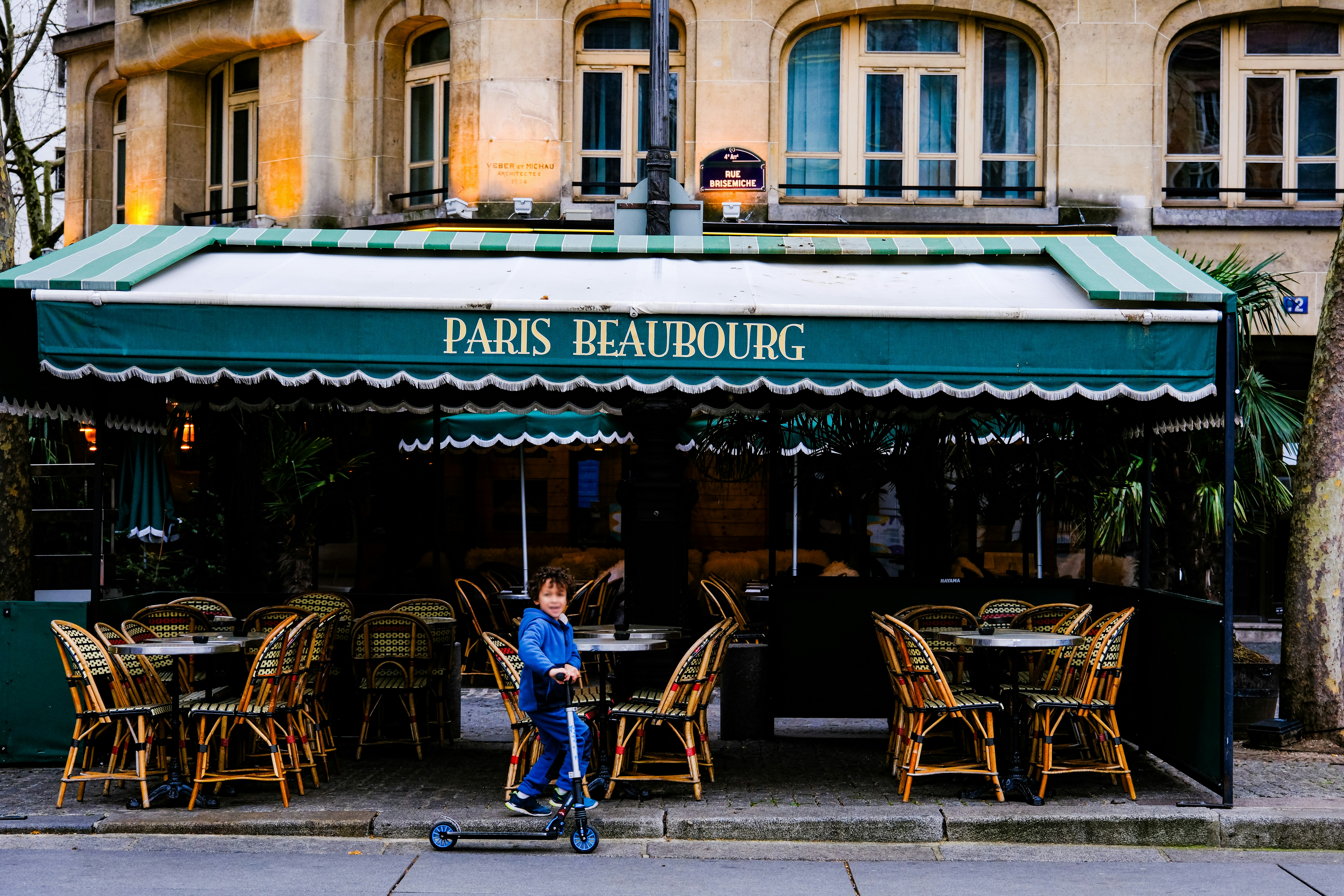 a person riding a scooter in front of a restaurant