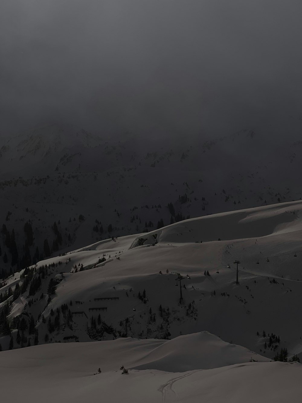 a snow covered mountain with a dark sky in the background