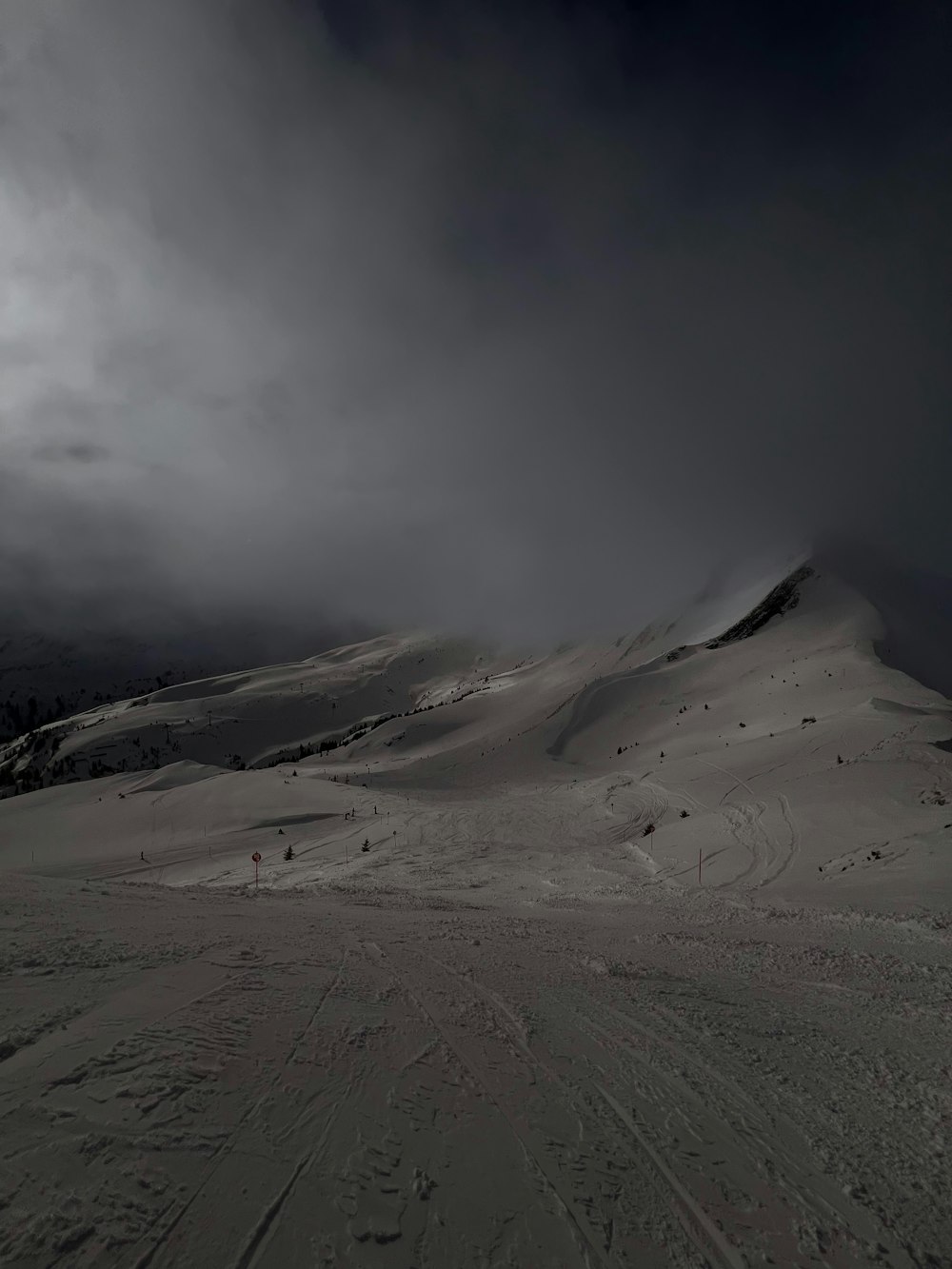 a snow covered mountain under a cloudy sky