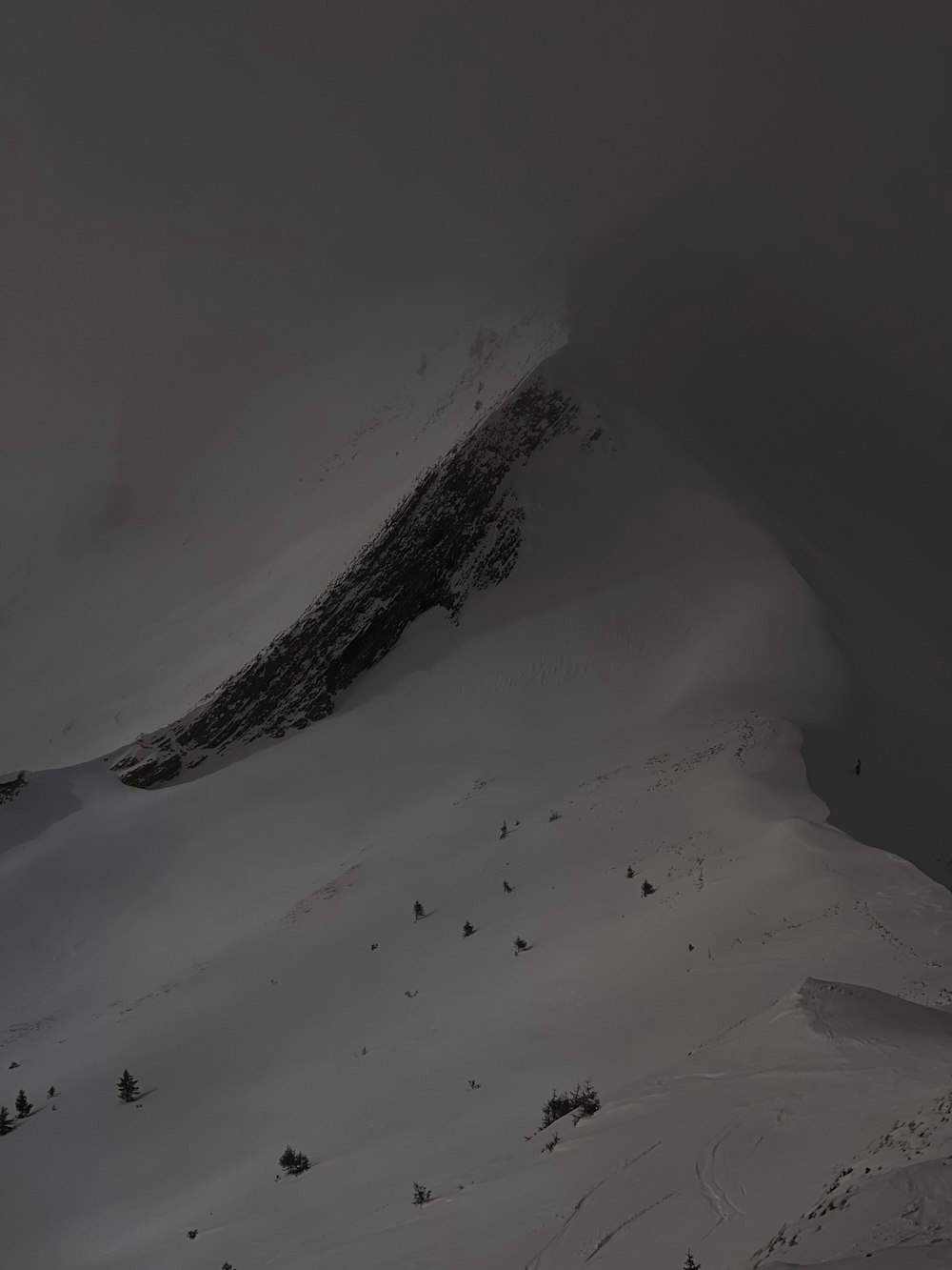 a mountain covered in snow with a sky background