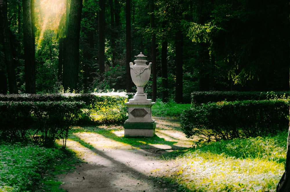 a statue in the middle of a path in a park