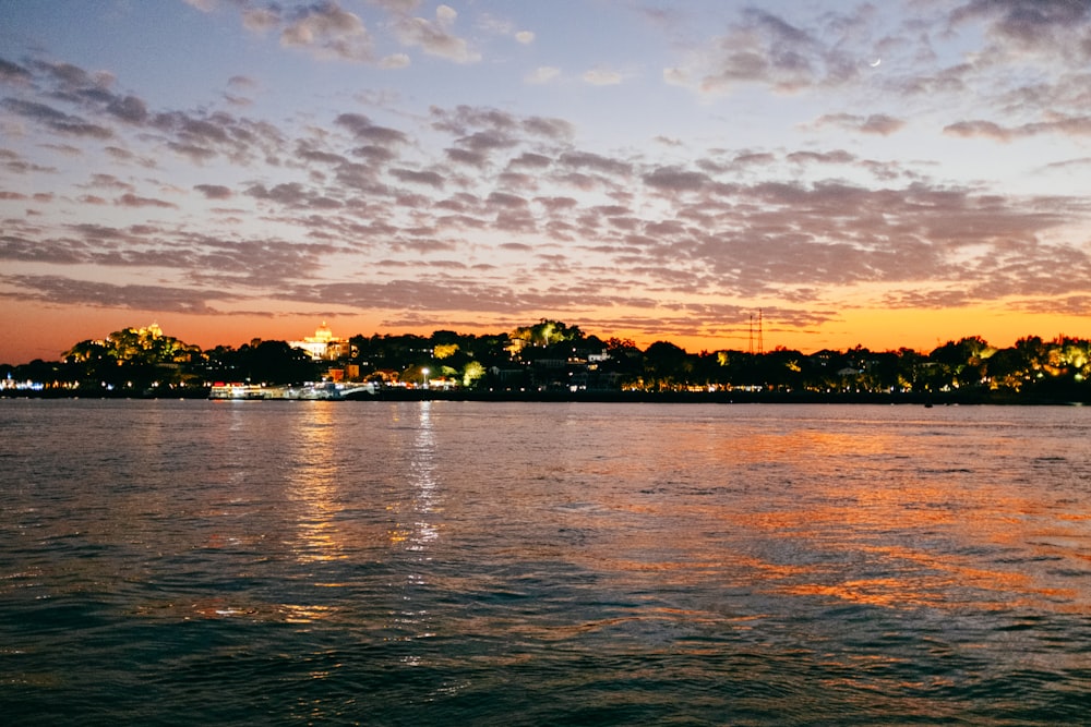 a body of water with a city in the background