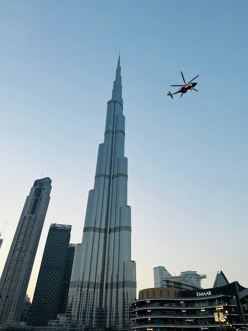 a plane flying over a city with tall buildings