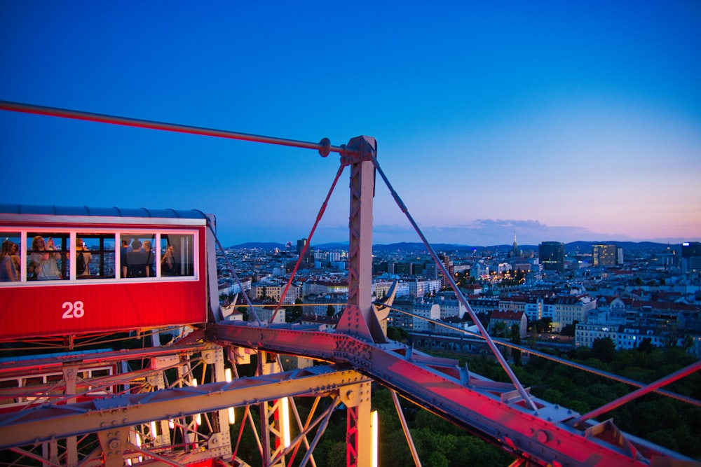 a red and white train traveling over a bridge