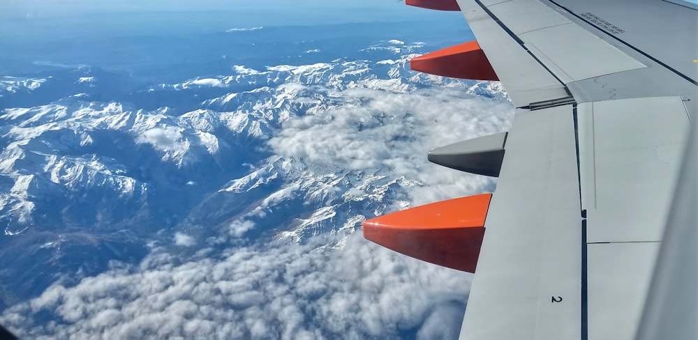 the wing of an airplane flying over a mountain range