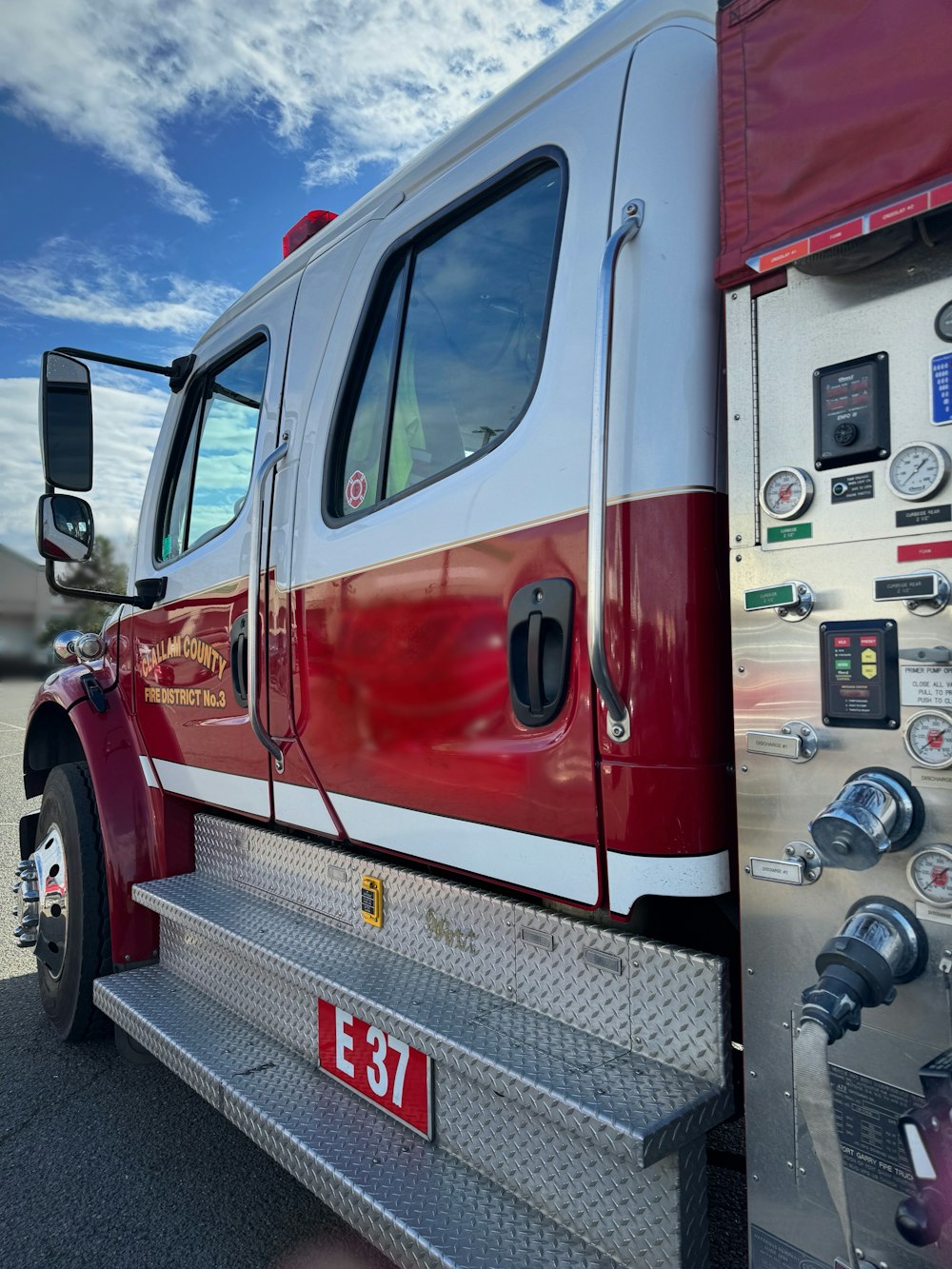 a red and white fire truck parked in a parking lot