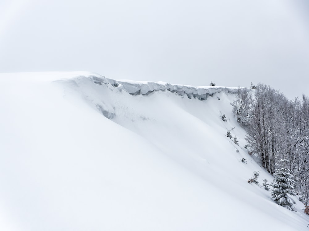 a man riding skis down a snow covered slope