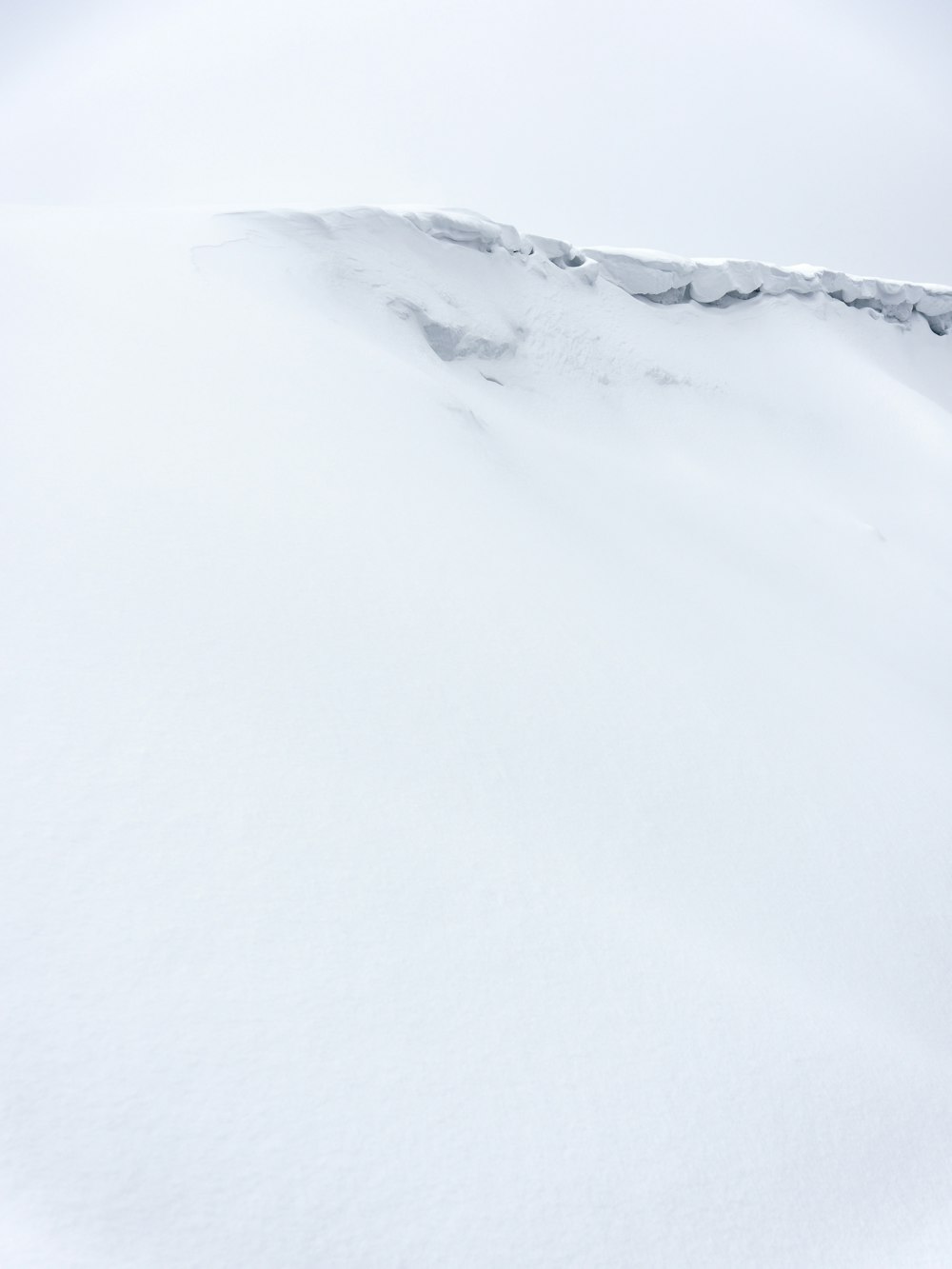 a man riding skis down a snow covered slope