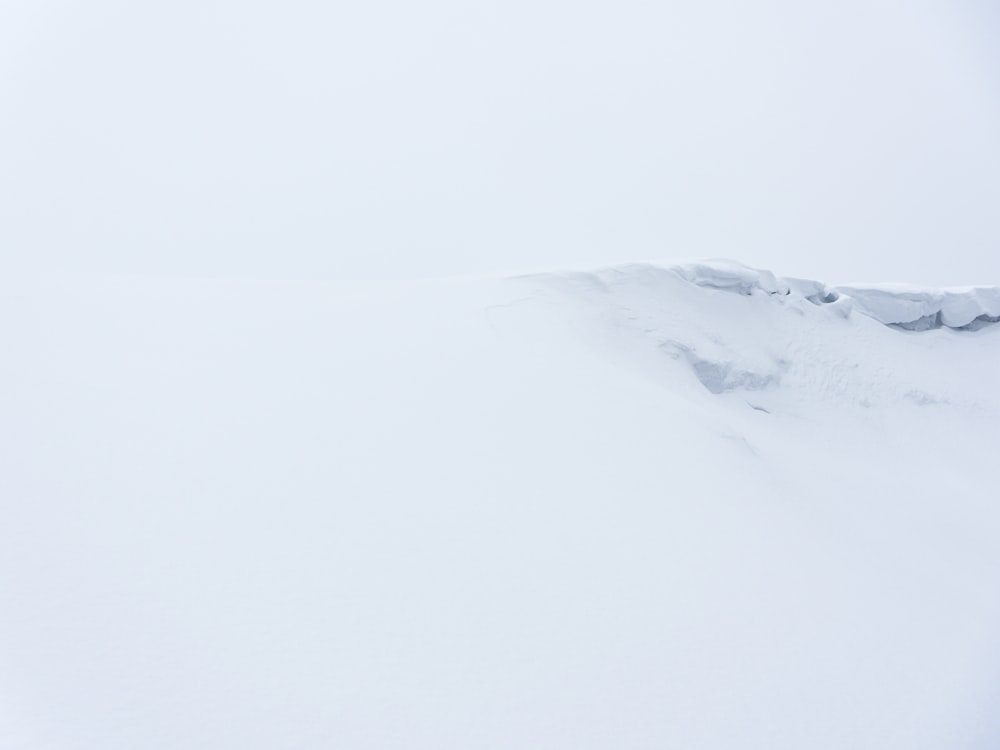 a man riding skis down a snow covered slope