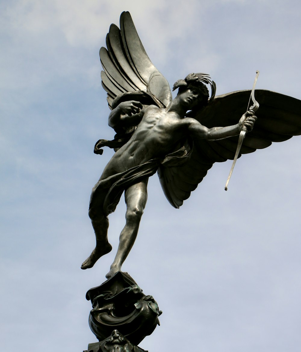 a statue of a man holding a flag on top of a building