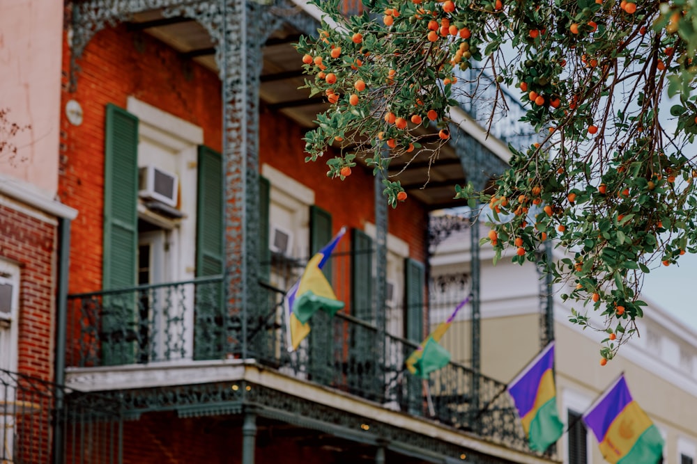 a building with a bunch of flags hanging from it's balconies