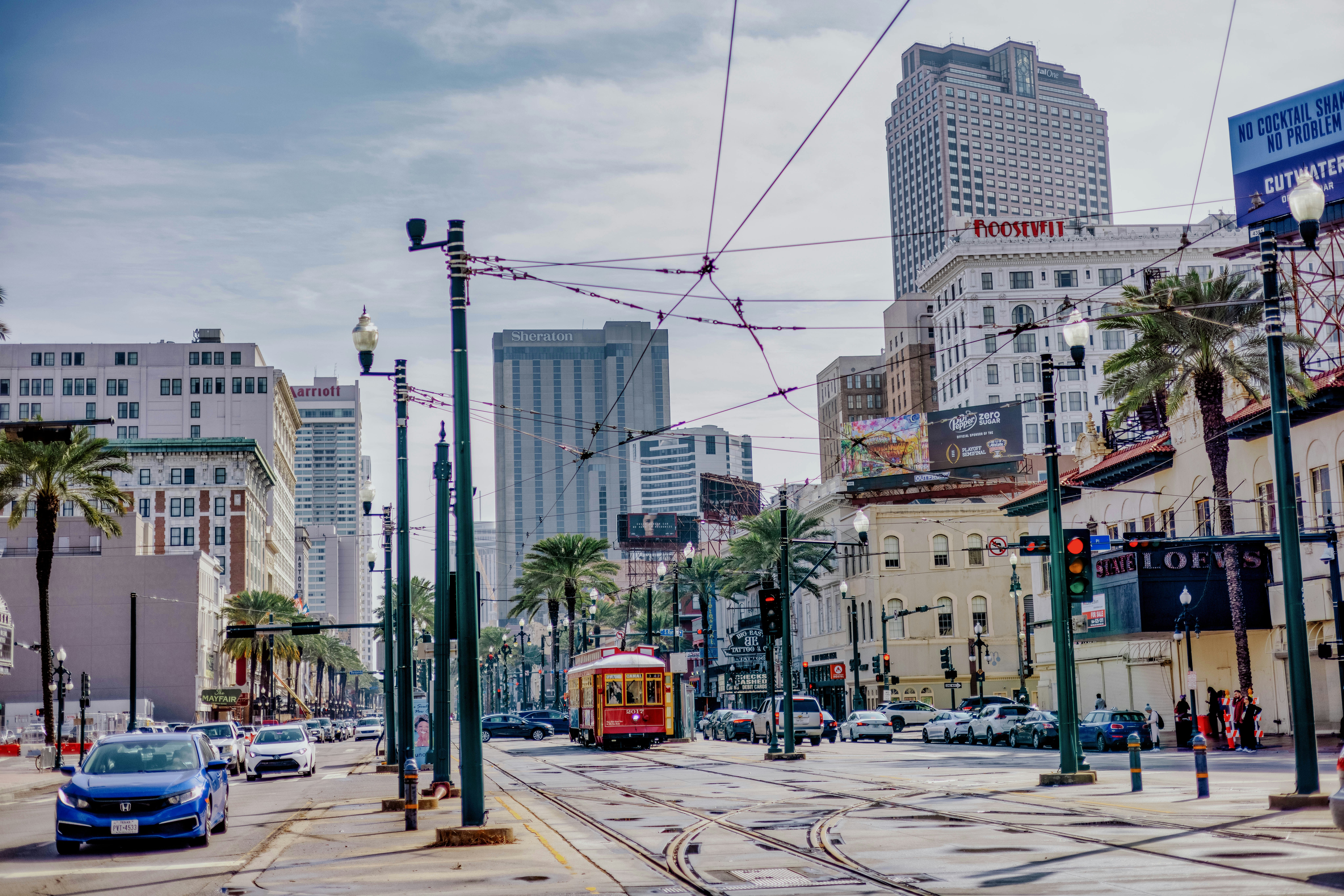 a street scene with a trolley on the tracks