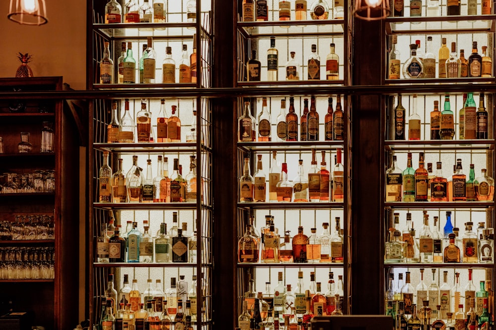 a wall of liquor bottles in a bar