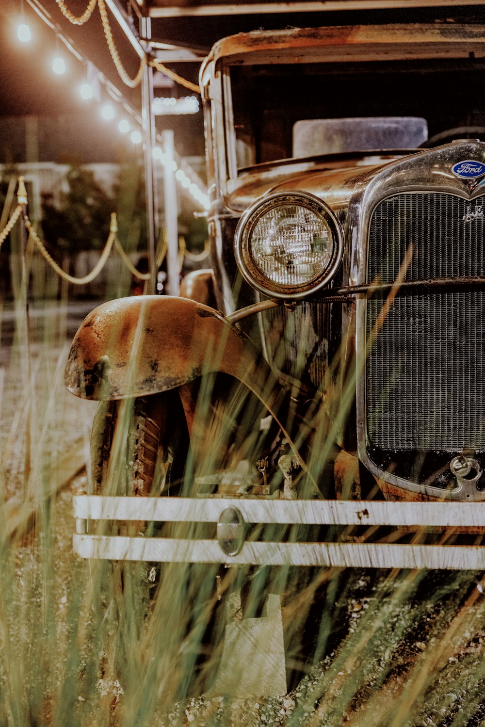 an old truck is parked in a field