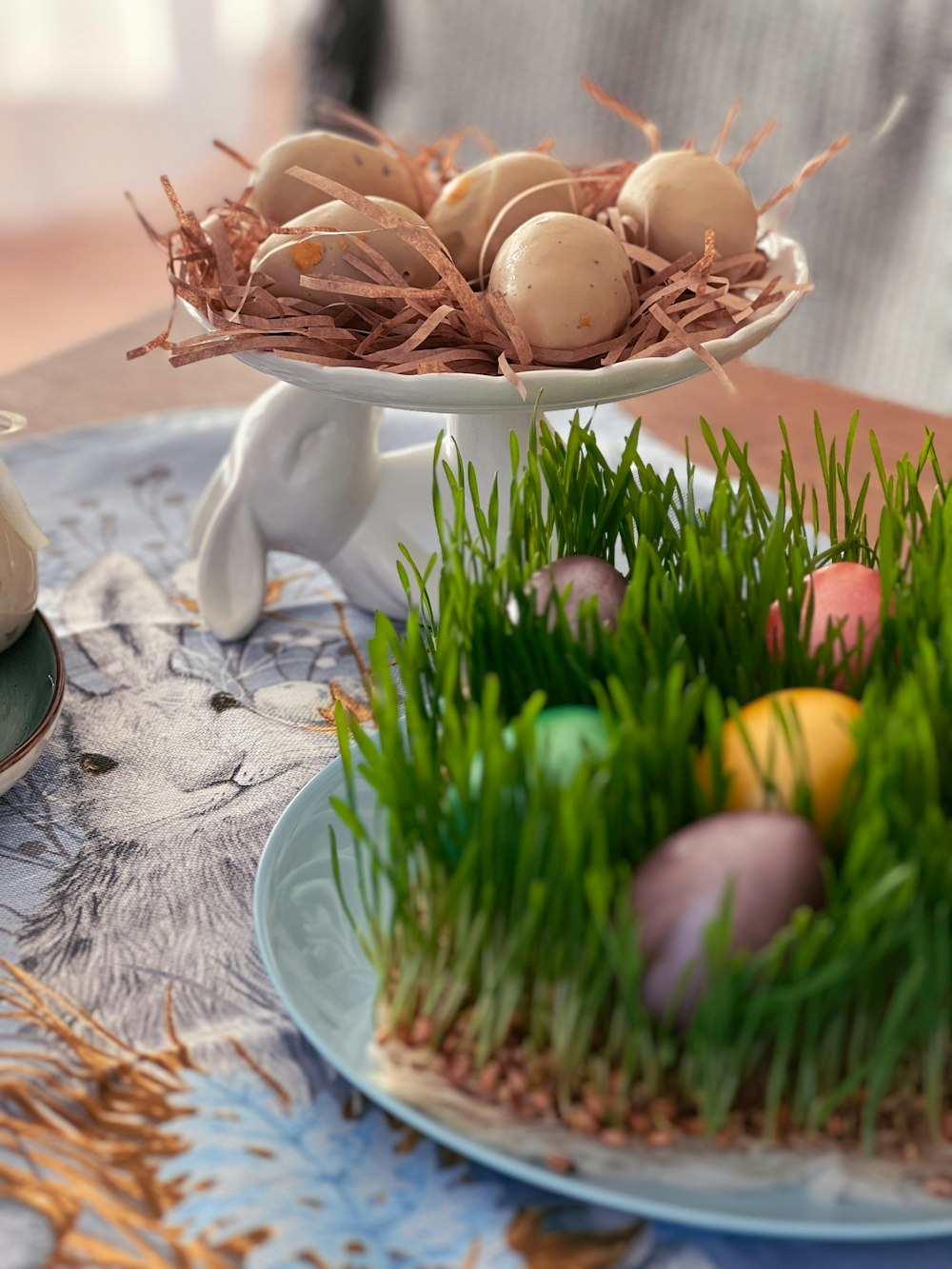 a plate of eggs and grass on a table