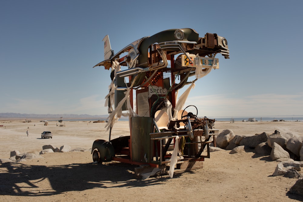 a large metal structure sitting on top of a sandy beach