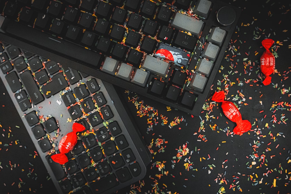 a keyboard and a computer keyboard covered in confetti