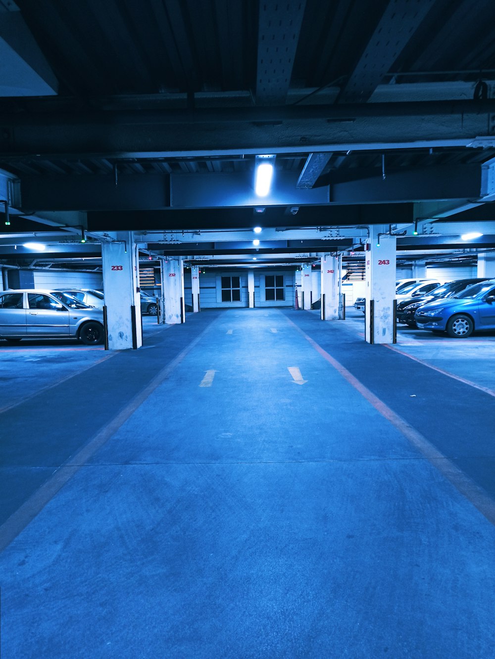 a parking garage filled with lots of parked cars