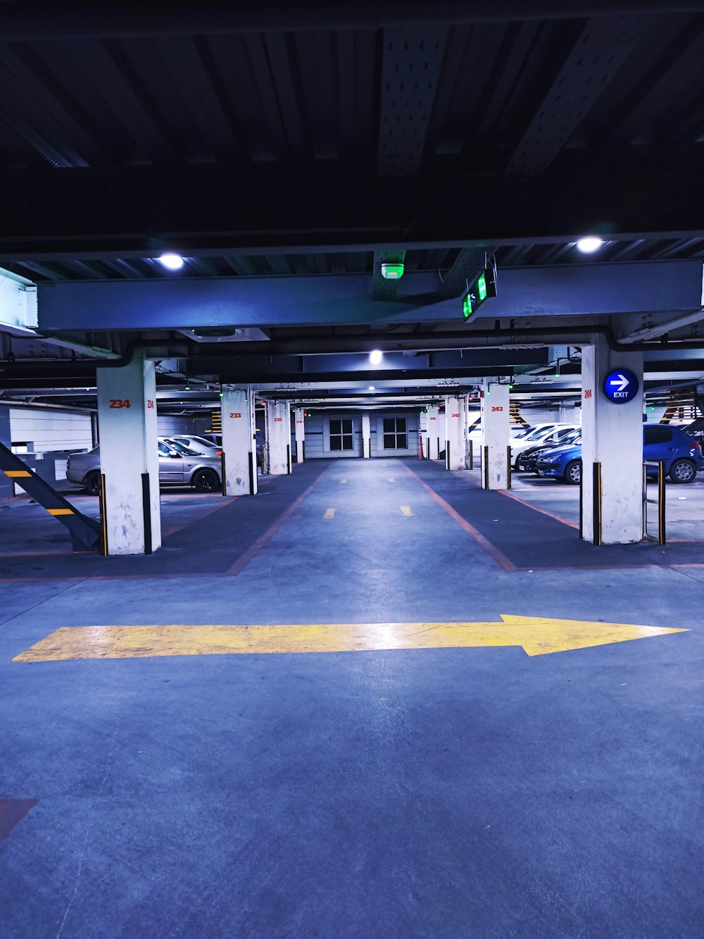 a parking garage filled with lots of parked cars