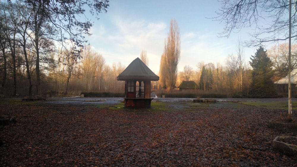 a gazebo in the middle of a park surrounded by trees