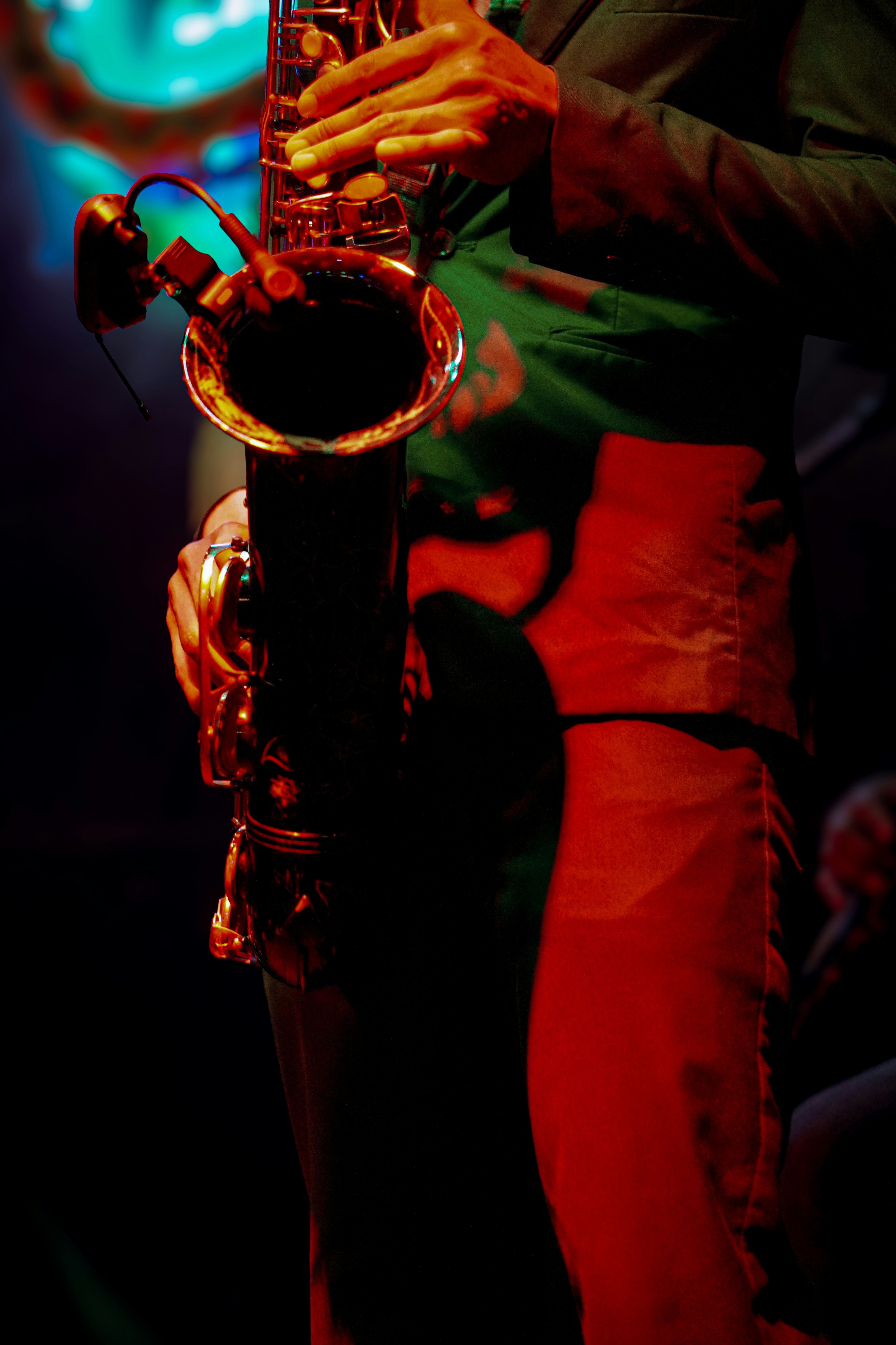 a person playing a saxophone in a dark room