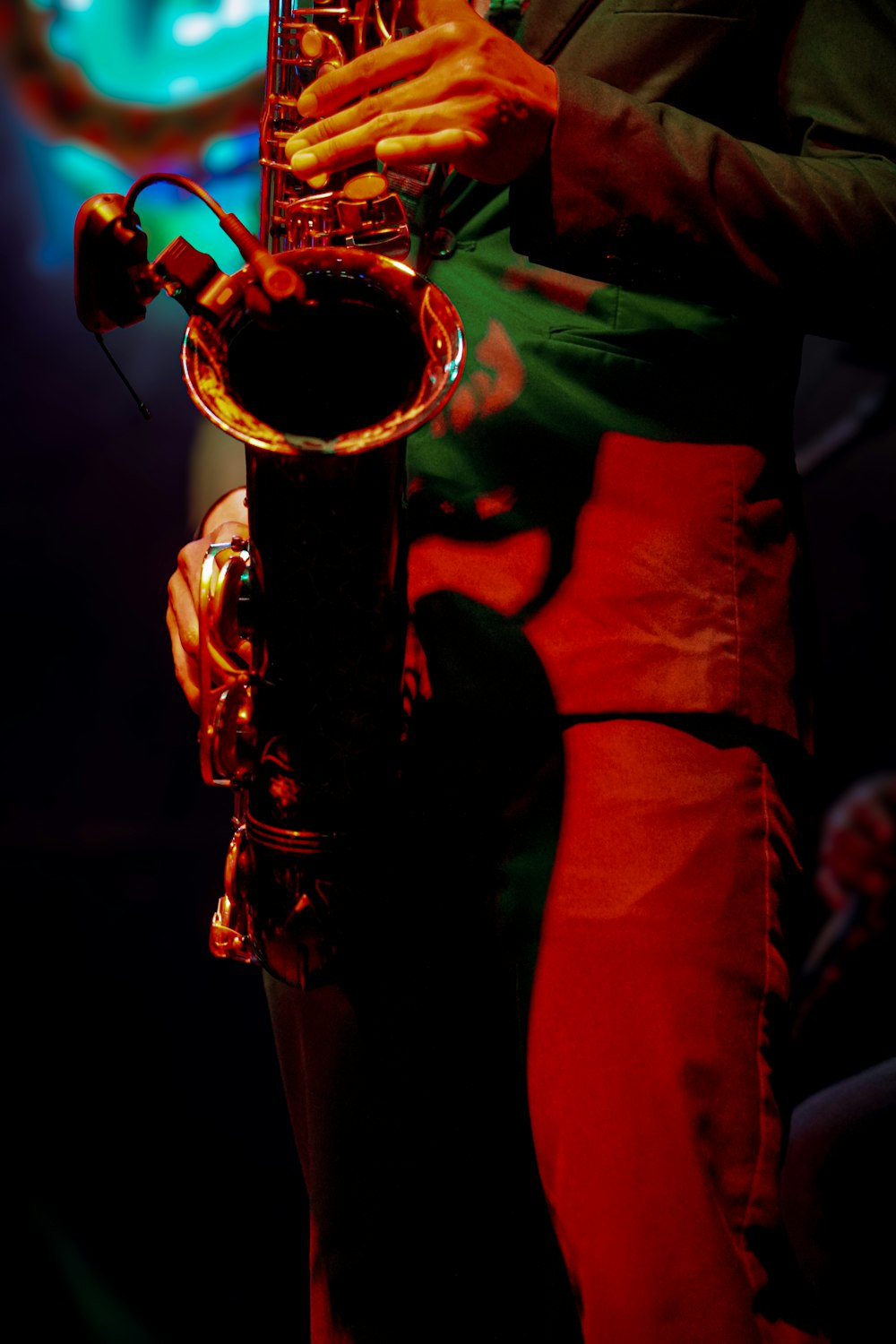a person playing a saxophone in a dark room