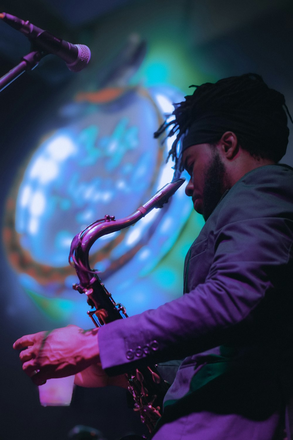 a man with dreadlocks playing a saxophone