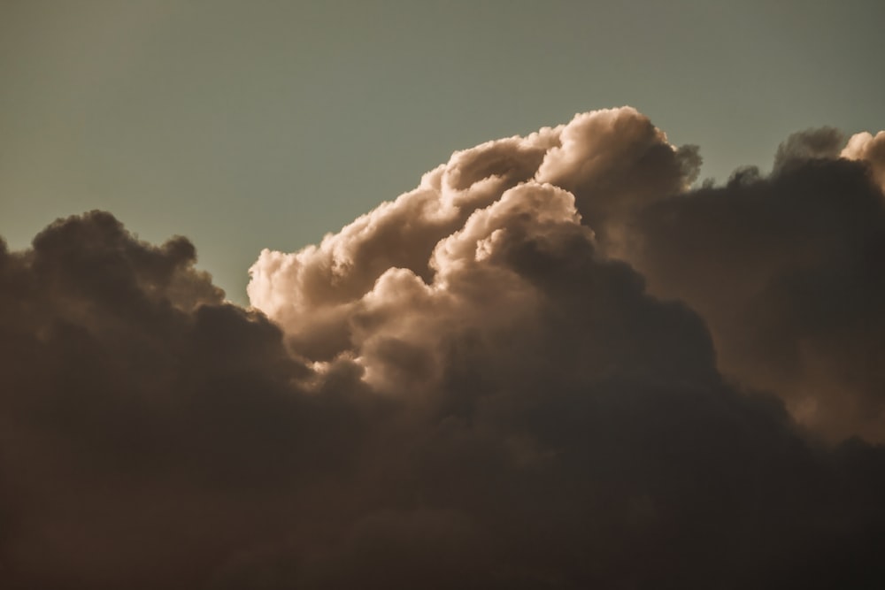 a plane flying in the sky with a lot of clouds