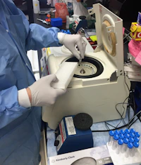 a person in a lab coat and gloves