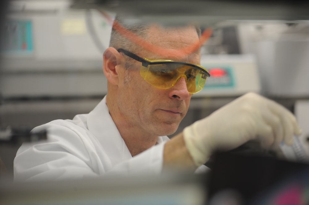 a man in a lab wearing safety goggles