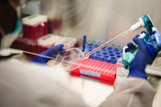 a person in a lab holding a pipe