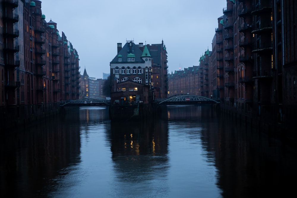 a river running through a city next to tall buildings