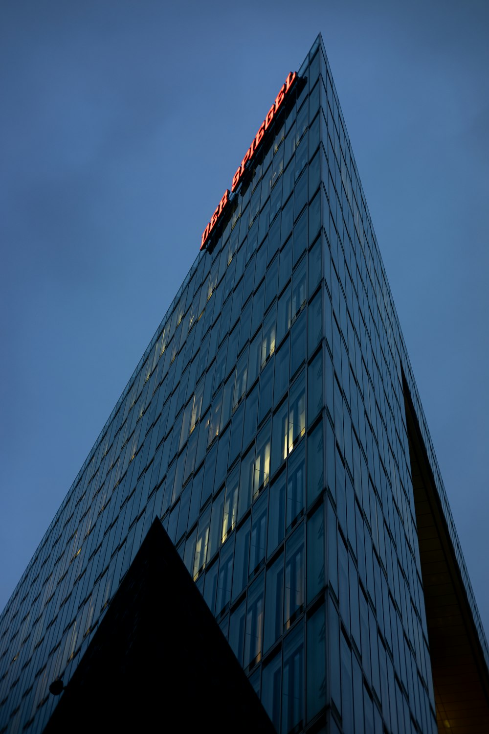 a very tall building with a red light on top of it
