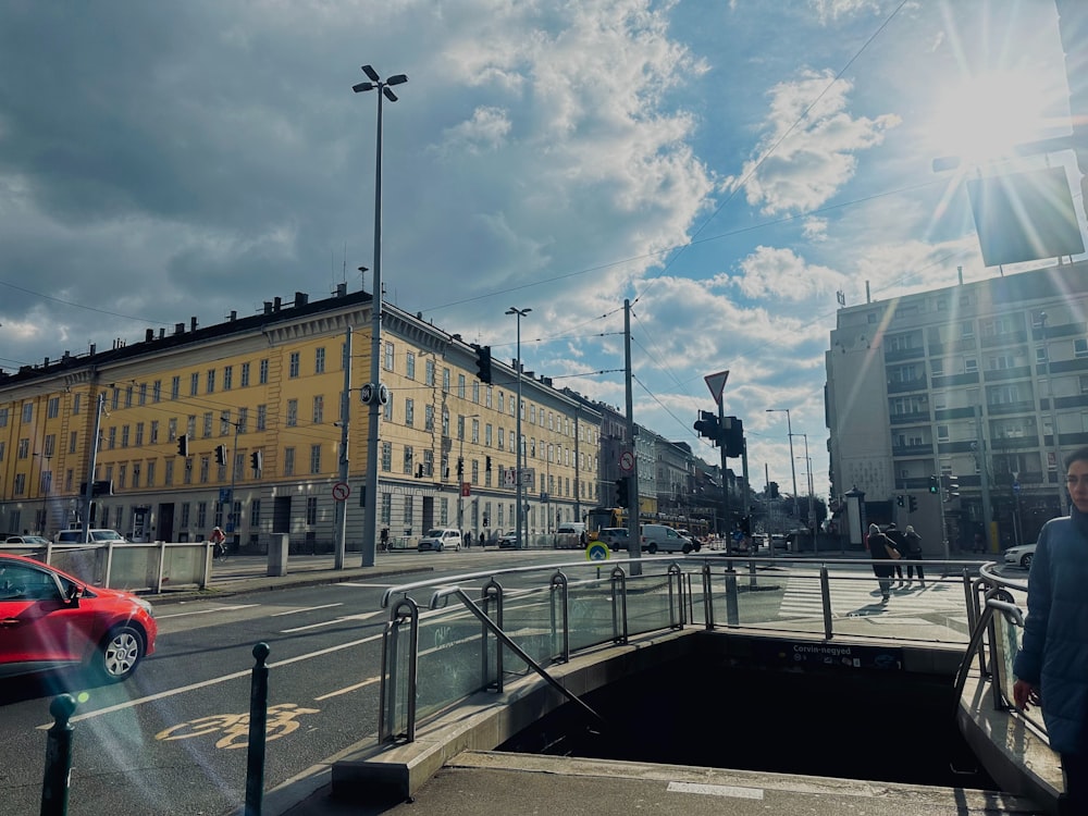 a man walking across a bridge over a street